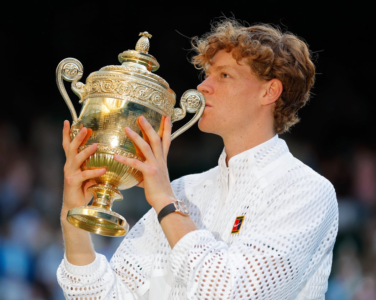 Jannik Sinner celebrates winning the Wimbledon 2026 men's singles title by kissing the trophy on Centre Court